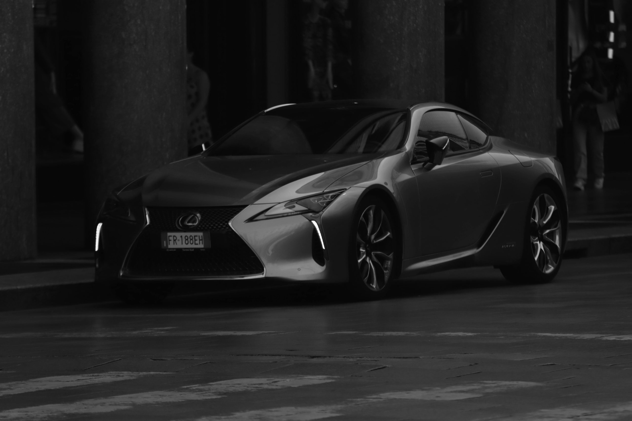 Sleek Lexus captured in black and white on a quiet street in Turin, Italy.